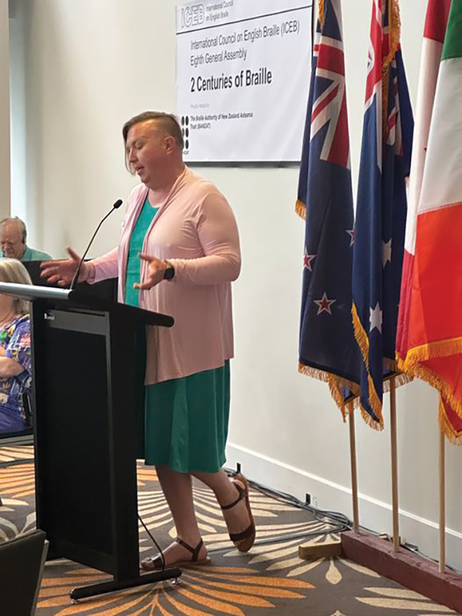 Photo of Willow Gene Free giving a presentation behind a podium