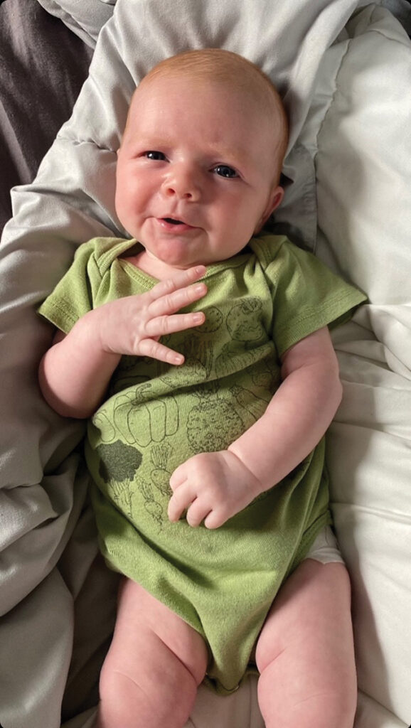 photo of a baby in a green onsie