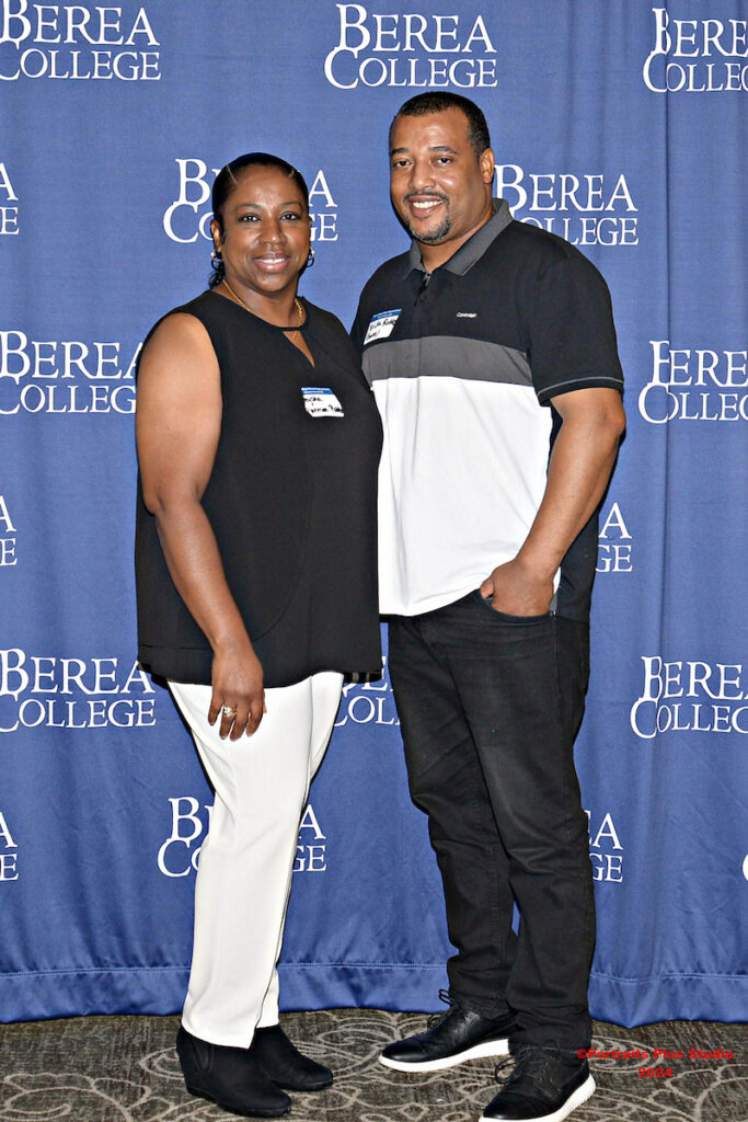 Two Greenville alumni pose in front of a Berea College backdrop