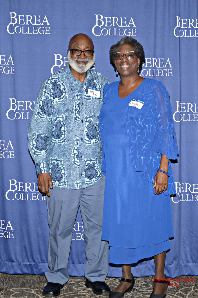Two Greenville alumni pose in front of a Berea College backdrop