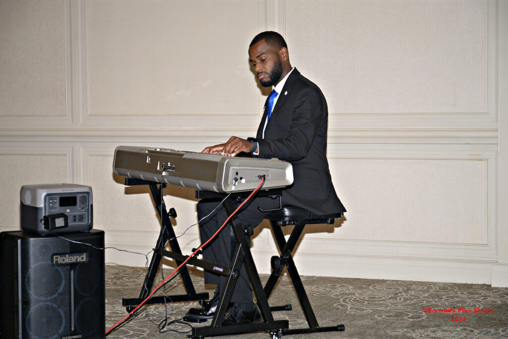Young man playing the keyboard at the Greenville alumni gathering