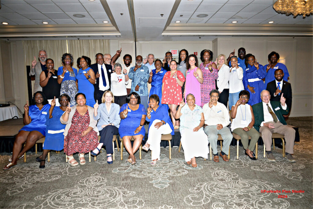 Group photo of the Greenville Alumni gathering participants holding up  No. 1 fingers