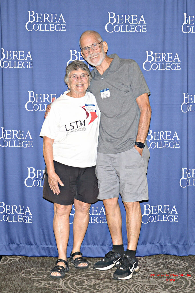 Two Greenville alumni pose in front of a Berea College backdrop