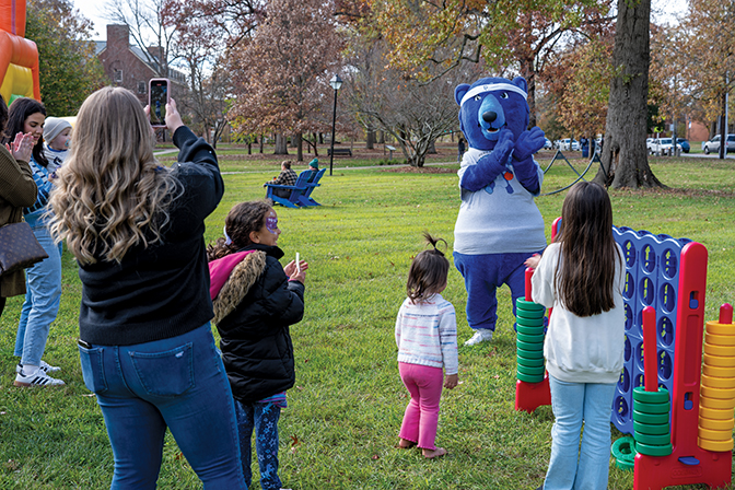 Blue the mascot claps with children during Berea Fest