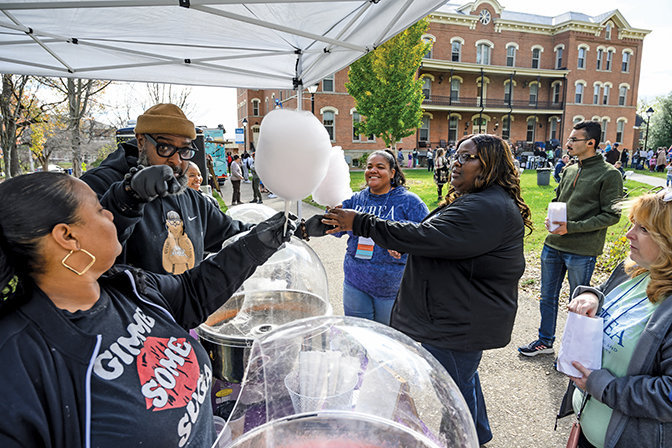 People handing out cotton candy at Berea Fest