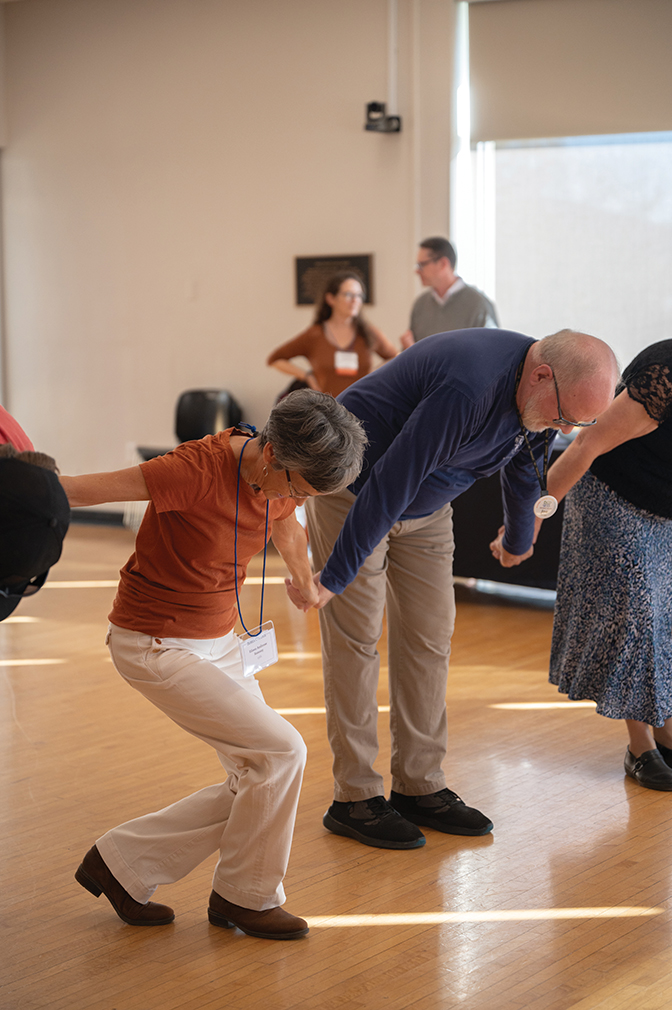Alumni dancers taking a bow after a Country Dancers dance