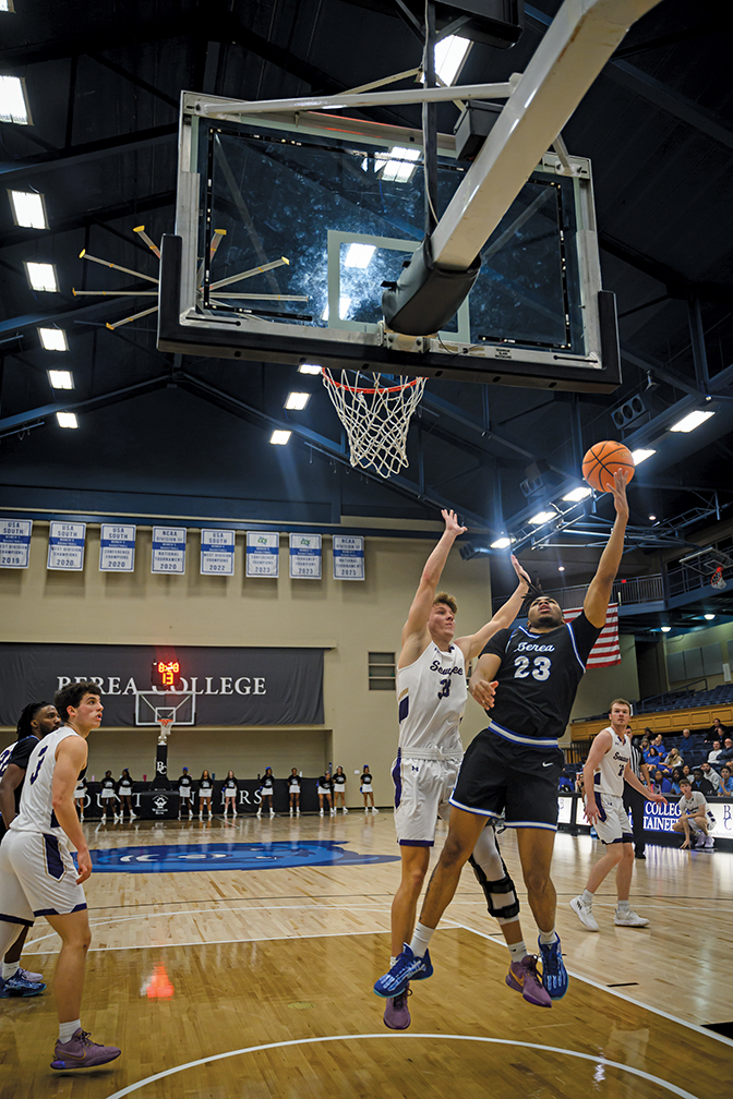 Berea basketball player attempting a layup with another teams' defender guarding him