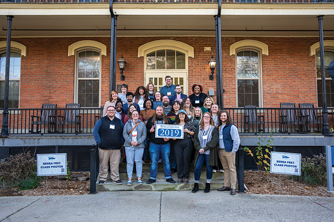 Members of the Class of 2019 stand on the steps of Fairchild holding their sign.