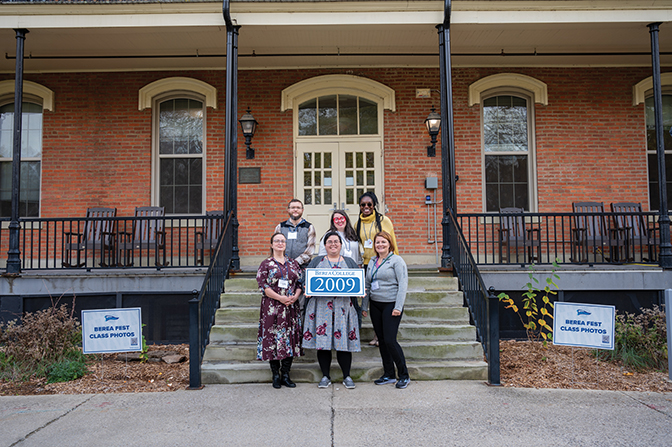 Members of the Class of 2009 stand on the steps of Fairchild holding their sign.