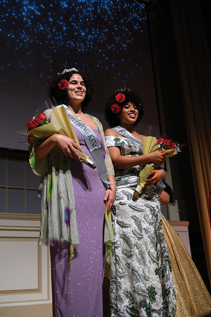 Two students holding roses as they were crowned the winners of the Black Student Union Pageant