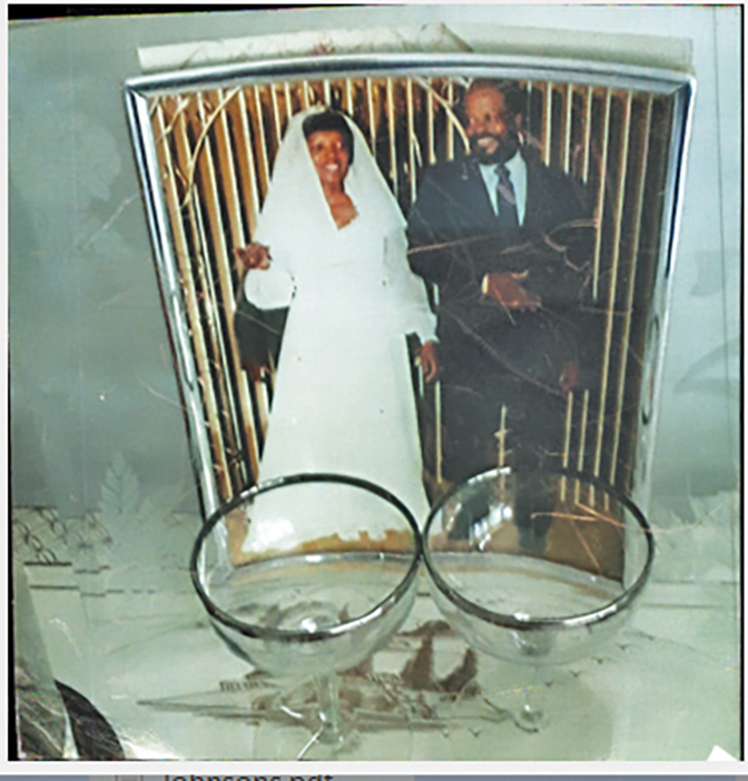photo of a wedding picture in a frame with two champagne glasses in front