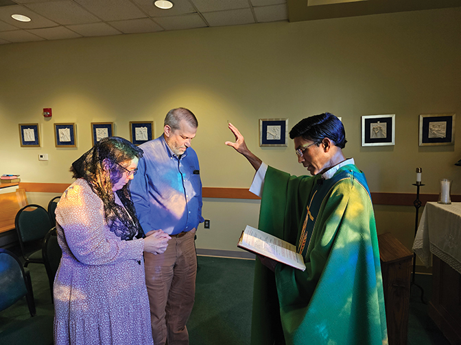 Photo of Amy Zucker and her husband, James, being blessed by a minister at their vow renewal