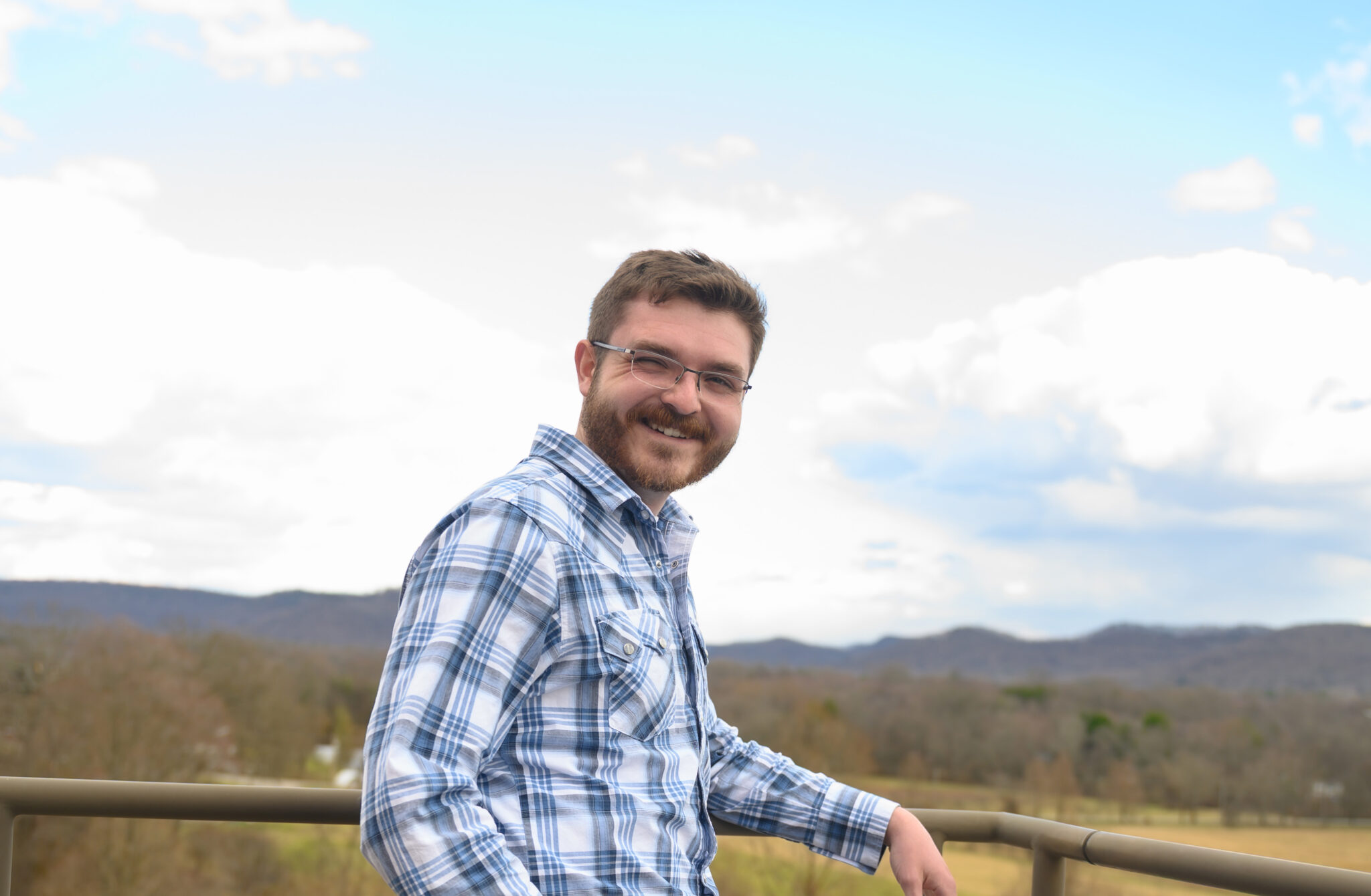 Portrait of Adam looking out over Alumni Fields at Berea College