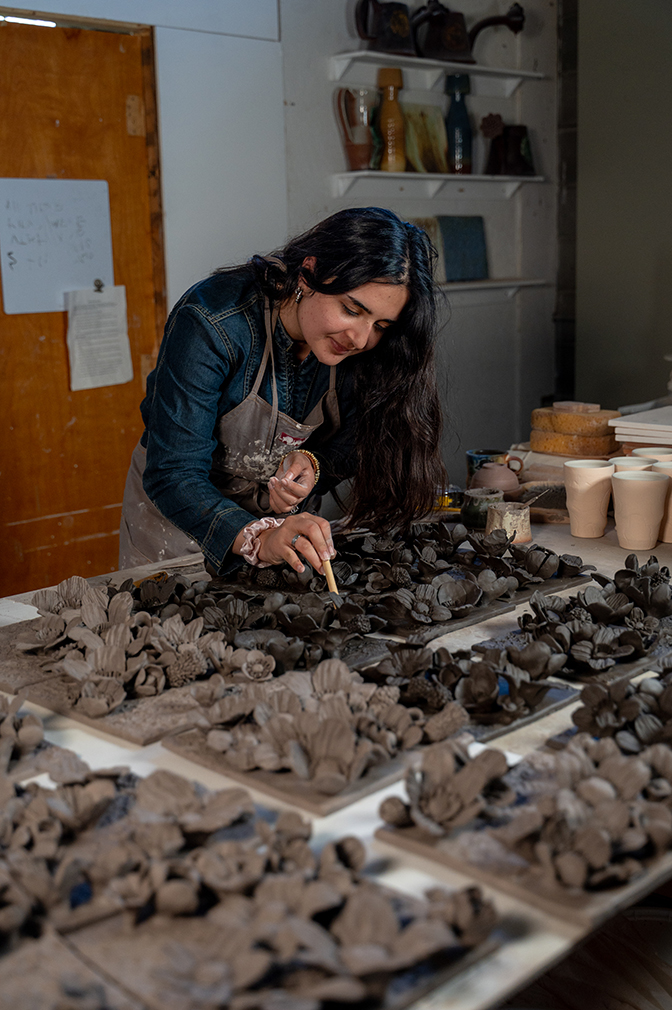 Portrait of Faryal '27 painting ceramic flowers