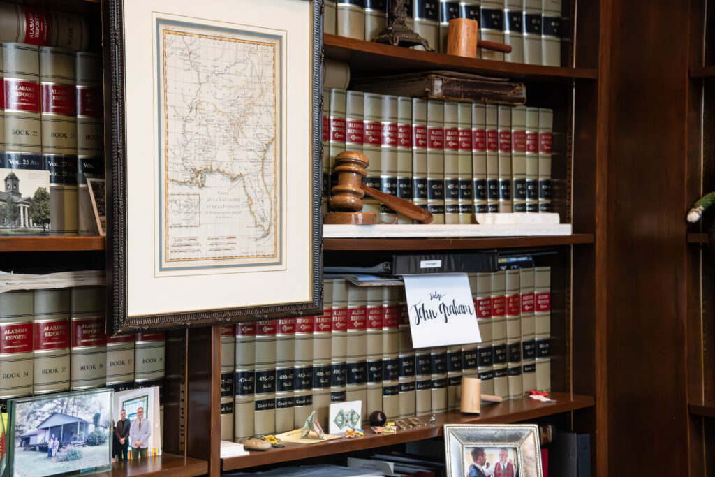 image of a library of books with a judge's gavel sitting in front of them
