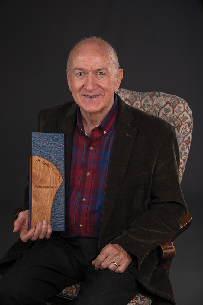 Portrait of Dr. David Nickel '64 holding his alumni award