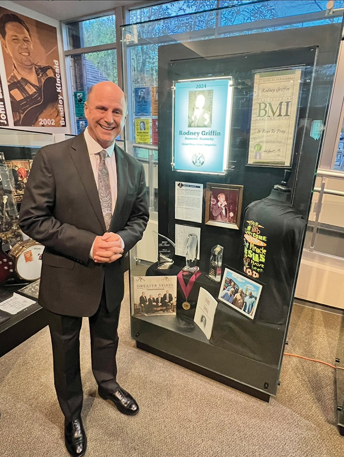 Photo of Rodney Griffin beside a display case
