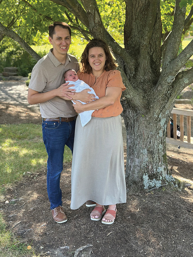 Picture of Nathaniel Fouch and his wife, holding a baby.