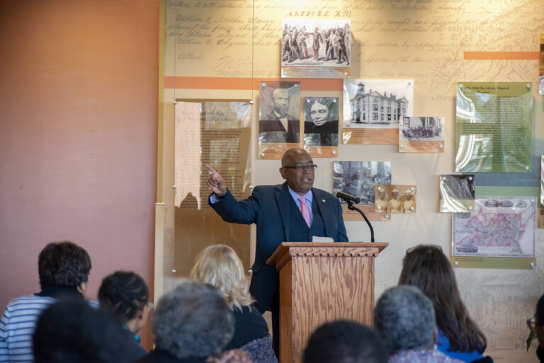 Andrew Baskin giving a speech in front of a crowd.