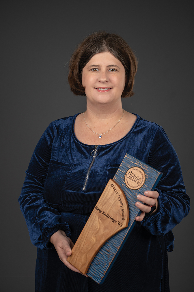 Portrait of Katy Sulfridge holding her alumni award.