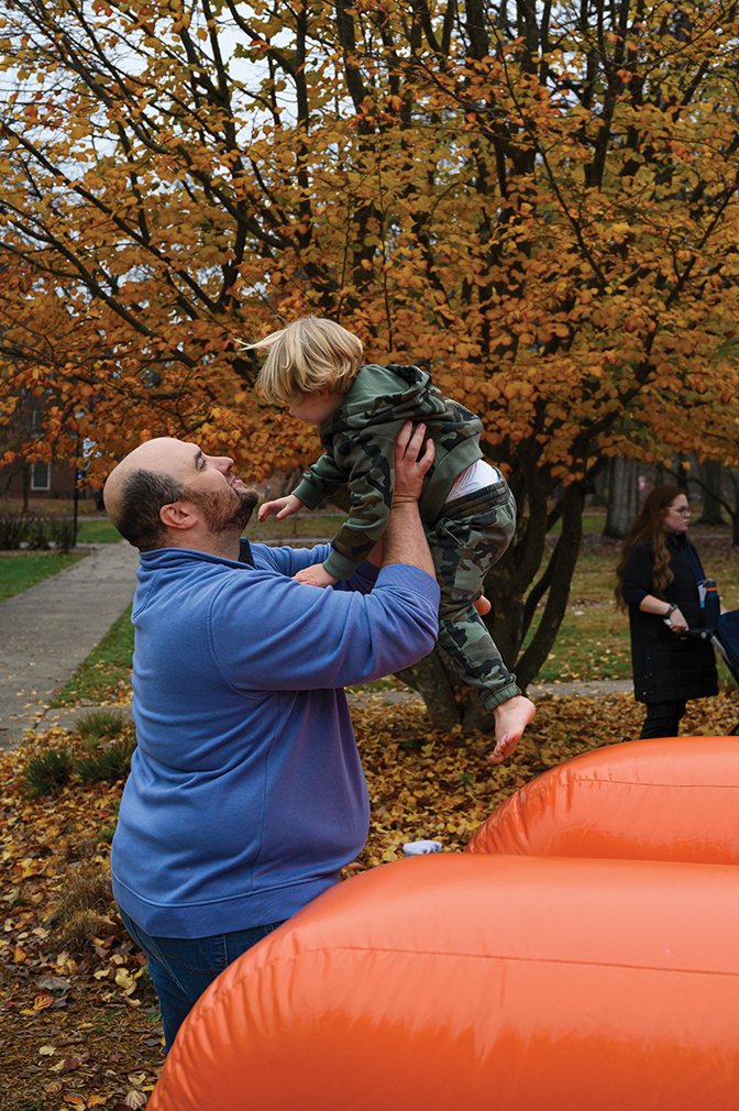 An alumnus plays with his child at BereaFest.