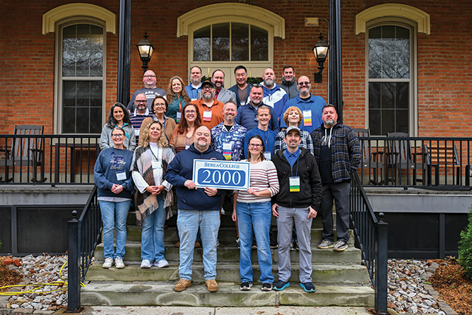 Members of the class of 2000 stand outside of Fairchild hall.
