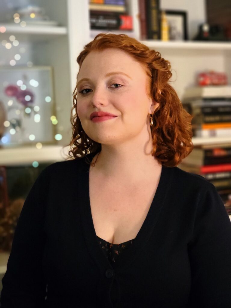 Image of Carolyn Grace in front of bookshelves