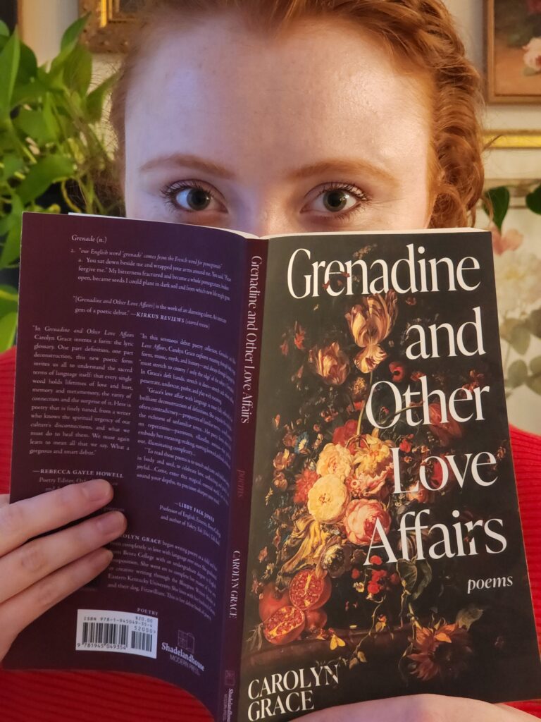 Carolyn Grace holding up her book, "Grenadine and Other Love Affairs."