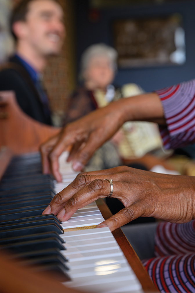 Upclose photo of Black hands playing the piano
