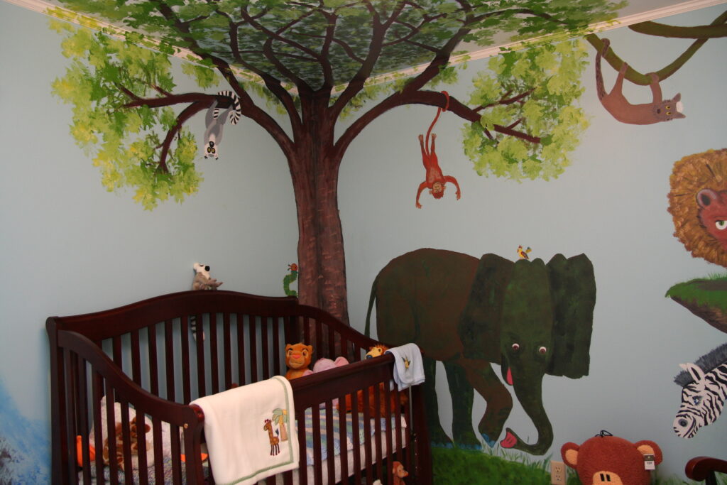Painted walls of a nursery done in Eric Carle style