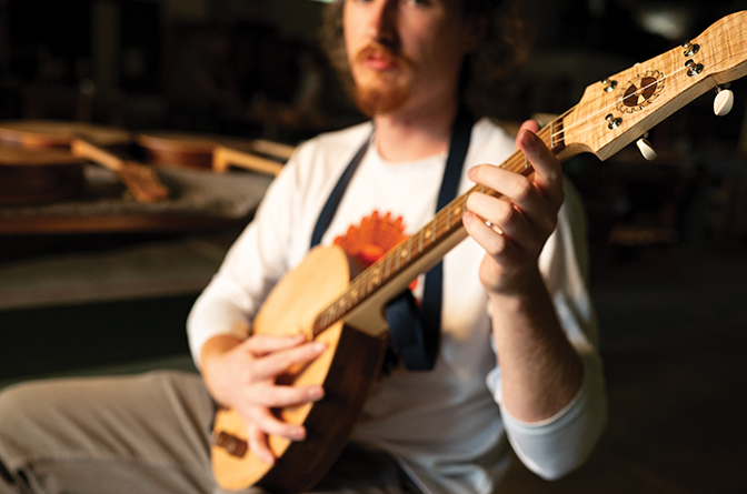 Up close shot of student holding a banjo.