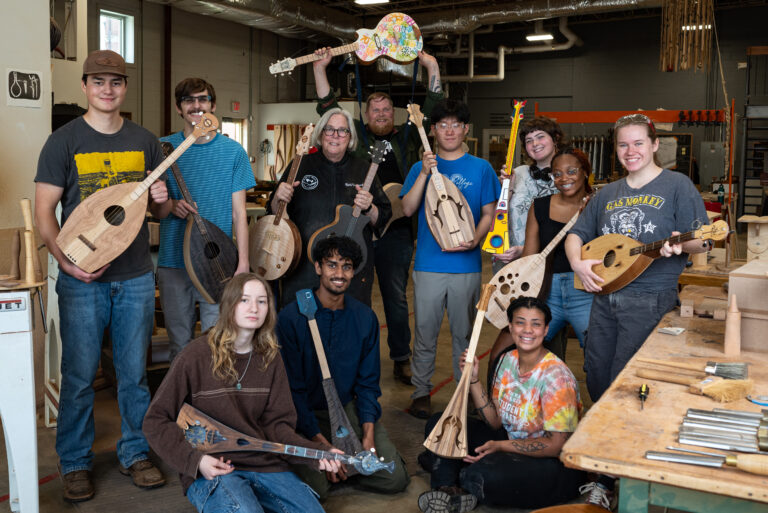 Students of Student Craft showing off their instruments with their instructor Rob Spiece.