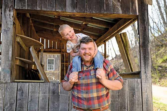 Photo of Matt Parsons with his son on his shoulders.