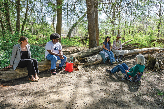Students sitting on a log after hiking up the Pinnacles