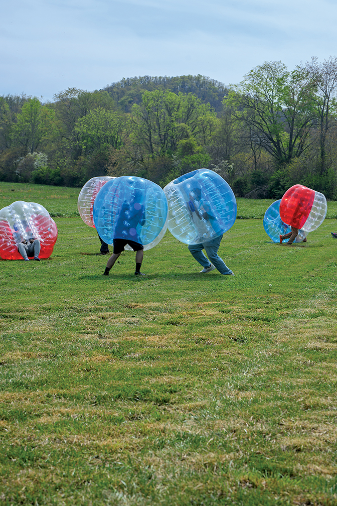 Students running around in giant bubble balls as part of fields games