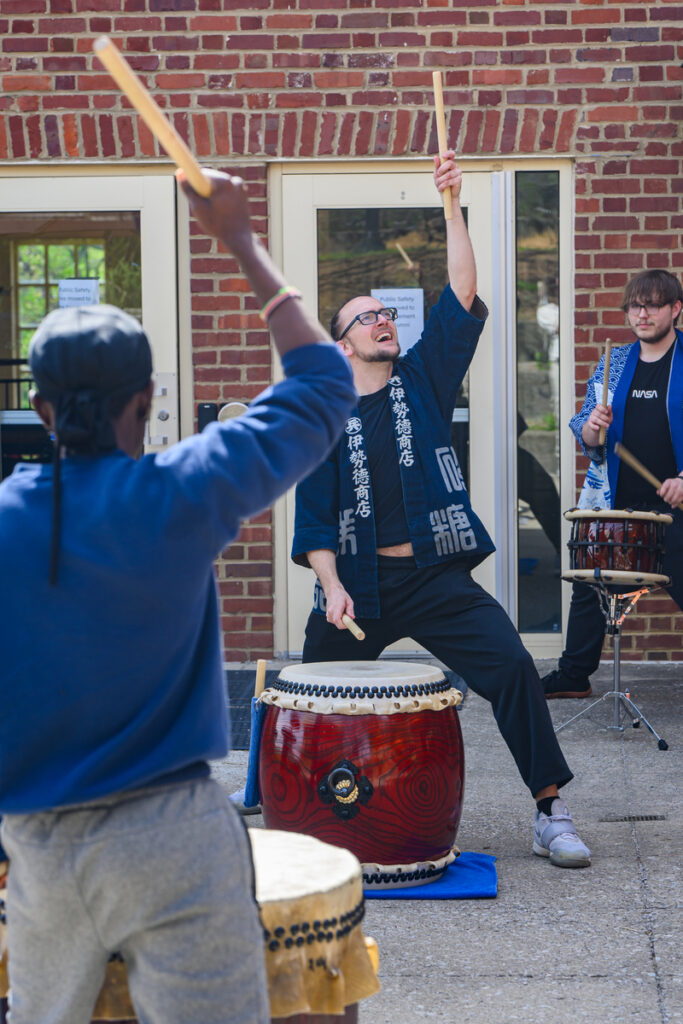 Students drumming outside of Woods Penn