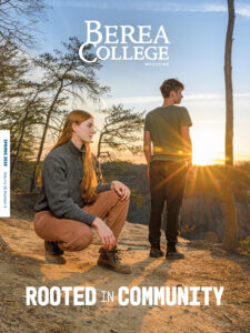 Cover of the Spring 2026 magazine, with an alumnus kneeling at the top of a mountain overlook and her spouse looking out over the sunset.