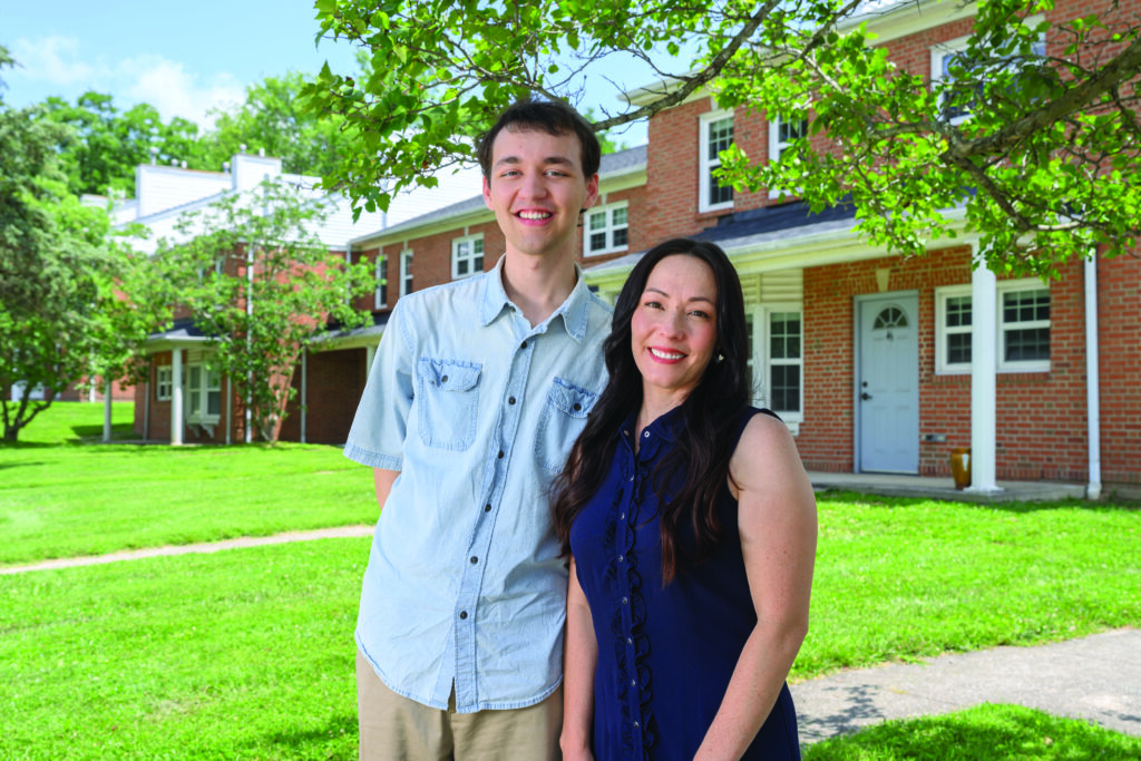Emily Puckett '07 poses for a photo with her son Benjamin Puckett outside the Ecovillage at Berea College.